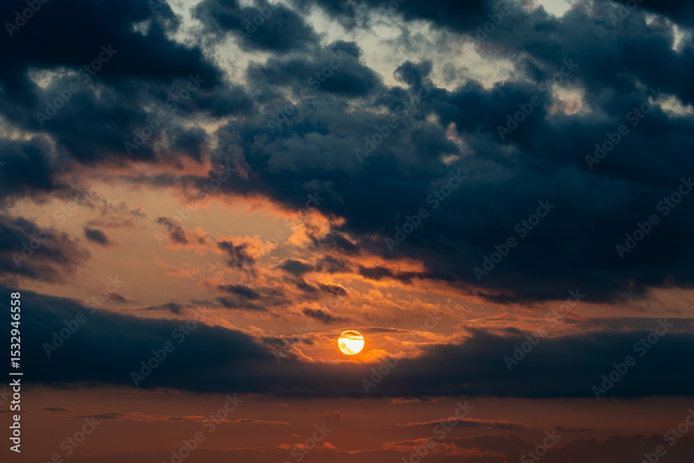 Fototapeta premium Dark dramatic horizon sky during sunset. Black clouds and setting sun