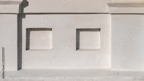 The white base of an old building as a background.