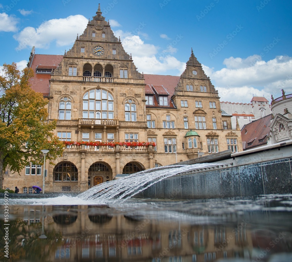 Naklejka premium Old Bielefeld town hall from below with the fountain in the foreground on a nice day