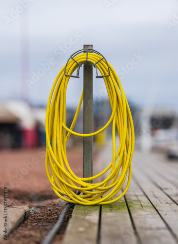 Yellow extension cord coiled on dockside holder.