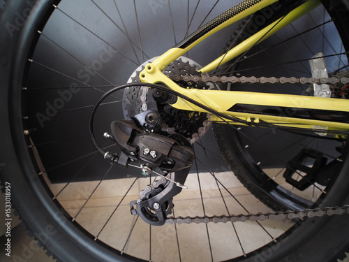 Close-up. Mountain bike rear gear system displays the derailleur, chain, and cassette.