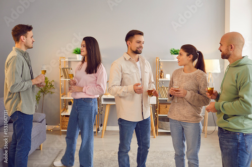 Diverse company of friends, coworkers or colleagues communication during event or party celebration. Holding glasses of wine or champagne, happy people and enjoyable gathering.
