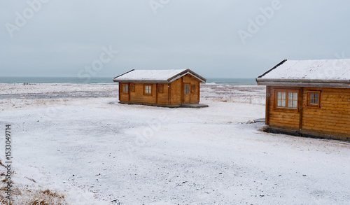 Wooden holiday cabin frozen land in winter. Iceland