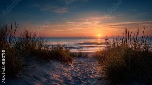 Golden sunset casting warm light over sandy dune beach with tranquil waves and serene coastal horizon view