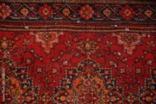  Red traditional oriental rug background. Close-up of a richly patterned red oriental carpet with intricate details and floral designs.