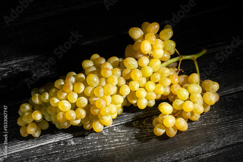 sultana seedless grape on black wood background