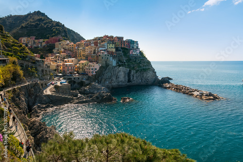 Colorful houses on the cliffs and the blue sea of Manarola, Cinque Terre, Italy.