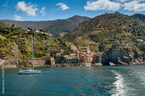 The seaside village of Vernazza, Cinque Terre, shines with colorful buildings...