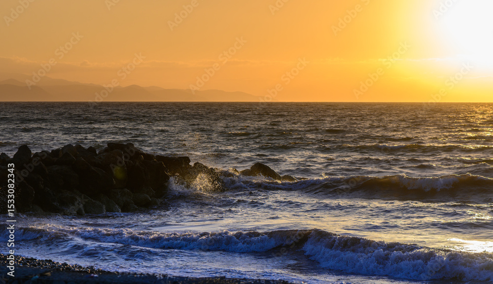 Fototapeta premium Golden sunset over the calm waters of the Mediterranean Sea in Cyprus.