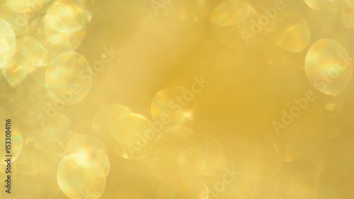 Shimmering gold bokeh effect with lens flare creates festive atmosphere in celebration design
