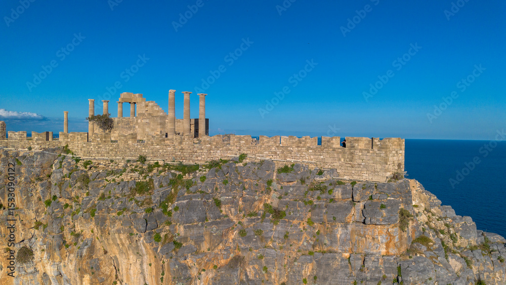 Obraz premium Rhodes, Greece. Lindos small whitewashed village and the Acropolis, scenery of Rhodos Island at Aegean Sea.