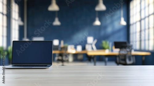 Laptop on light wood desk, blurred modern blue office background, sunlit