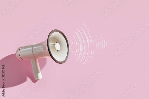 A megaphone creating sound waves on a pink background, symbolizing communication, expression, and promotion. 