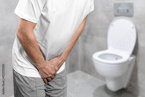 Person with urinary problems, Medical problem urinary incontinence. people with crotch pain, Man with hands on crotch with urinary problems	
