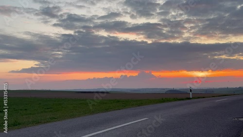 Sunset in the Luxembourg countryside and a secondary road on a spring evening