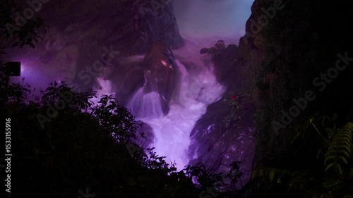 Purple light illuminates the Pailon del Diablo waterfall at night, Banos, Tungurahua, Ecuador