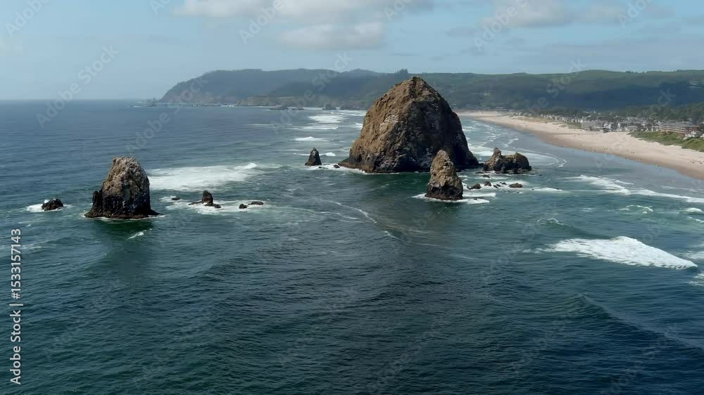 Aerial orbiting view of Haystack Rock off the coast of Cannon Beach, Oregon.