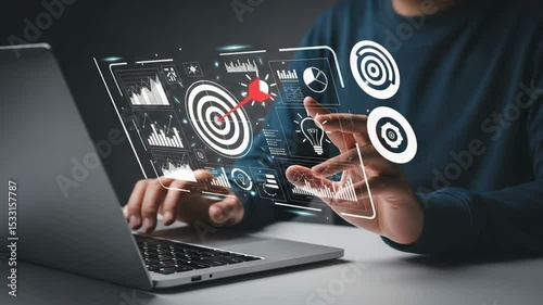 Man using laptop with digital overlay of target, graphs, and data visualizations displayed