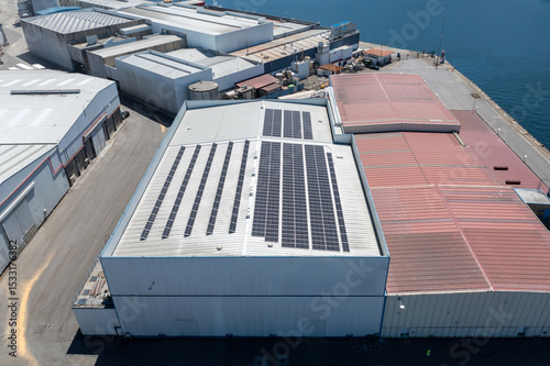 Industrial building using renewable solar energy on rooftop near ocean