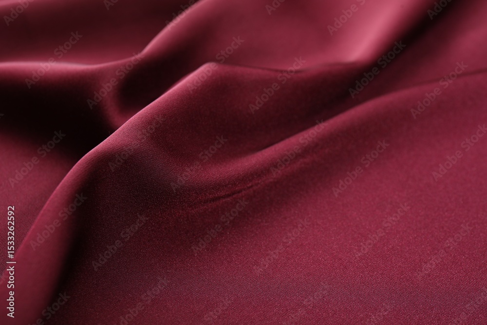 Fototapeta premium Crumpled burgundy silk fabric as background, closeup