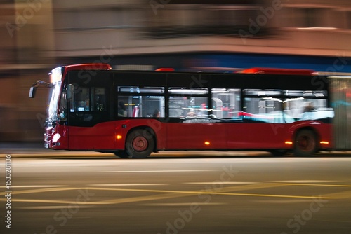 Valencia, Spain - March 19, 2025: Panning of public bus running in Valencia at night
