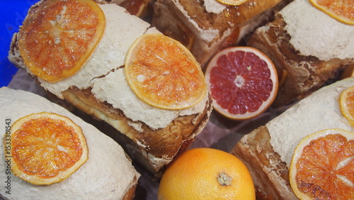 Homemade ricotta toast with caramelized orange slices and fresh grapefruit on rustic bread.