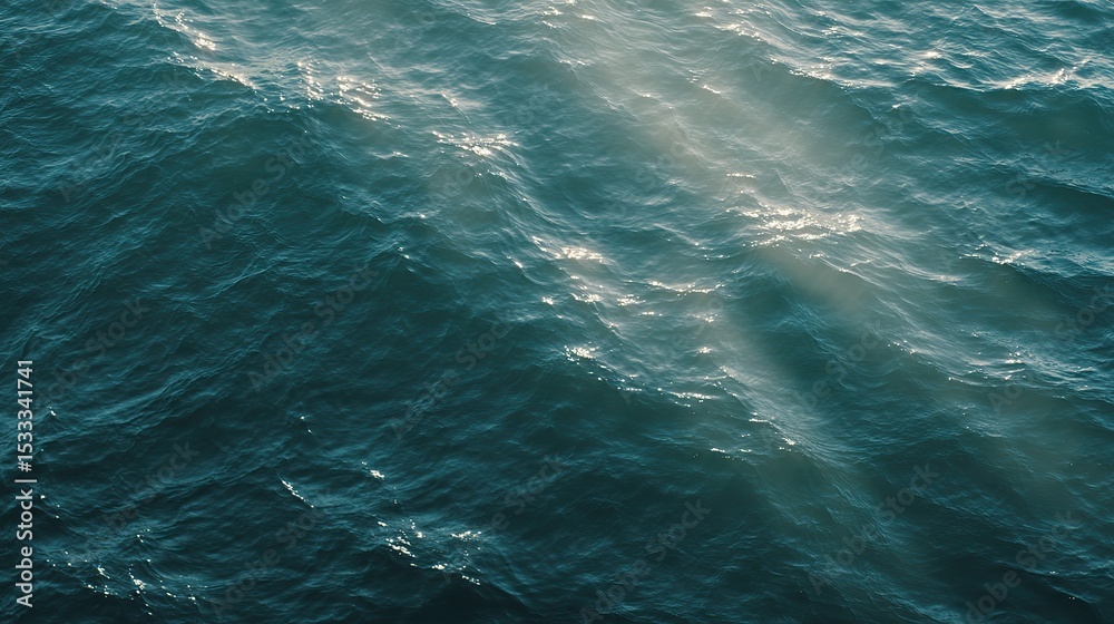 Obraz premium The calm sea, light blue-green tones, and the tranquil underwater view, where the sunlight reflects off the water's edge, creating a tranquil atmosphere. Gentle ripples and silence on the sea.