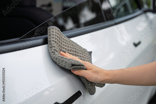 Carefully Wiping the Car Surface with a Cloth for Thorough Cleaning and Maintenance