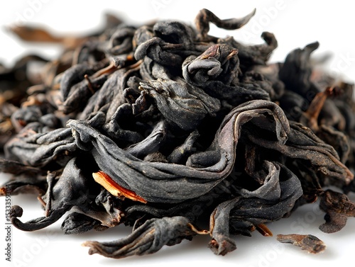 Aromatic black tea leaves pile up in an intricate heap ready for brewing a comforting hot drink soon now.