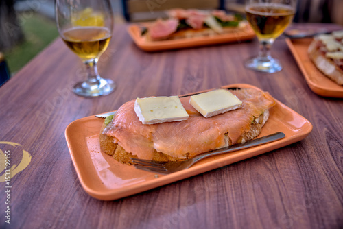 Madrid, Spain - June 1, 2025: Tapas and beverages on a restaurant patio table in the Getafe district in Madrid in Spain
