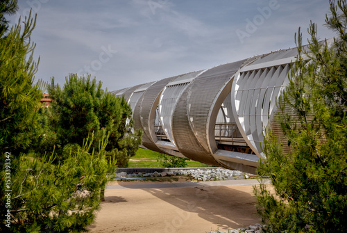 Madrid, Spain - June 1, 2025: The Arganzuela Footbridge in the Parque Madrid Rio along the Rio Manzanares in Madrid in Spain
