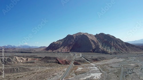 Drone view of Yadan landform near Kashgar in southern Xinjiang, China. High angle view of colorful mountains in sunny autumn day, 4k real time landscape footage b roll shot.