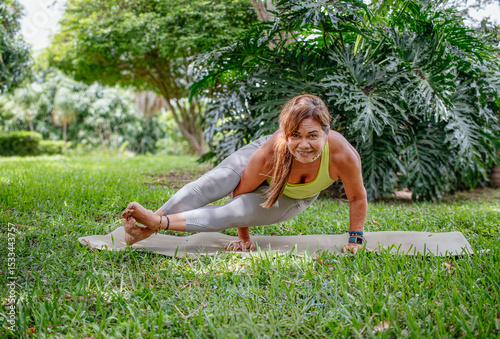 Ageless Strength: Happpy Mature Woman in Yoga Arm Balance