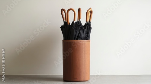 Wooden umbrella stand with black umbrellas.