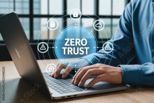 Hands typing on a laptop with a zero trust concept displayed.
