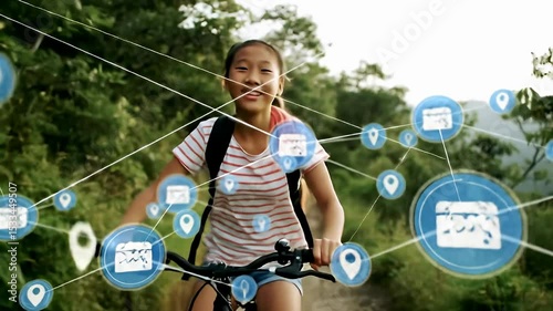 Young Girl Riding Bicycle Through Green Forest Park with Digital Overlay Showing Connectivity and Navigation