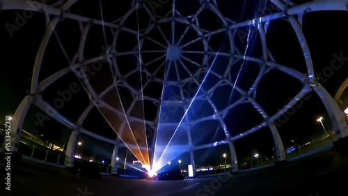 Nighttime Drone Footage of Illuminated Geometric Dome with Blue Lighting and Laser Effects