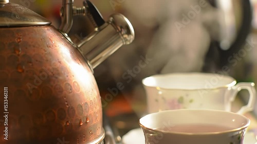 Closeup of Boiling Tea Kettle Pouring Hot Water into Teacup in Kitchen Setting