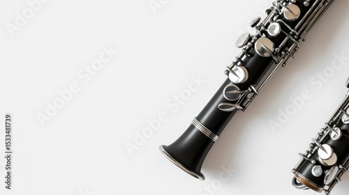 A clarinet with silver keys, leaving space on the right for text, against a white backdrop