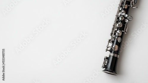 A clarinet with silver keys, leaving space on the right for text, against a white backdrop