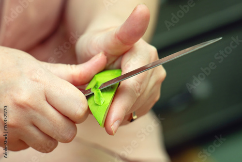 Dangerous knife technique while peeling an avocado, showing risky food preparation that could cause injury