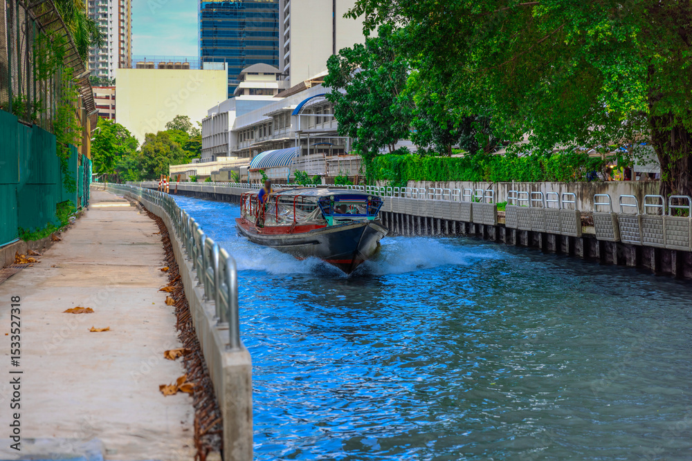 Fototapeta premium Ferry boat going through a Canal Khlong in Thai running from Soi 15 Sukhumvit Rd NANA to Soi 21 Sukhumvit Rd Asoke in BKK Bangkok Thailand