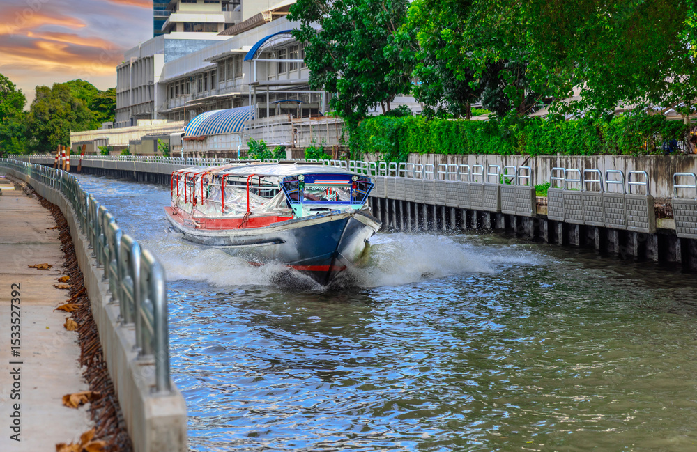 Naklejka premium Ferry boat going through a Canal Khlong in Thai running from Soi 15 Sukhumvit Rd NANA to Soi 21 Sukhumvit Rd Asoke in BKK Bangkok Thailand