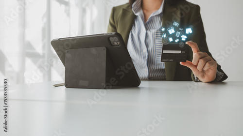 Online shopping and credit card payment concept, person is shopping on an online shopping website, purchasing goods and services securely, debiting credit card to pay for goods on the internet.