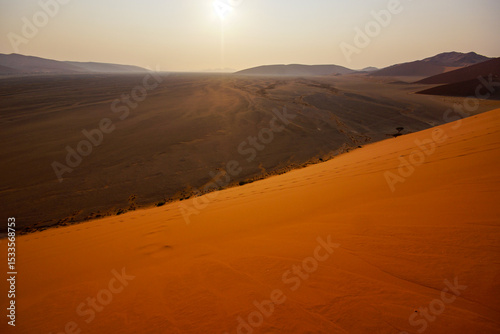 Fototapeta Naklejka Na Ścianę i Meble -  View from Dune 45 onto the plains of Sossusvlei at sunrise, Namib-Naukluft, Namibia