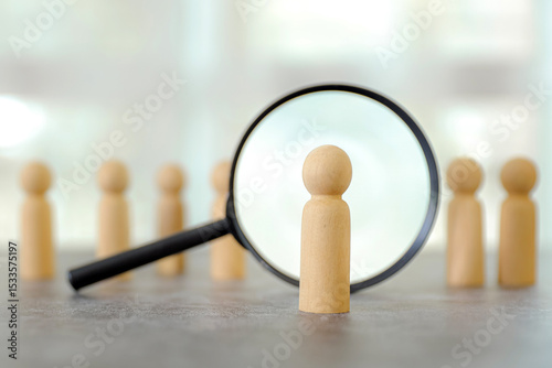 Magnifying glass search wooden person stands for HR human resources or personal leader training skill or leadership and challenge business team.