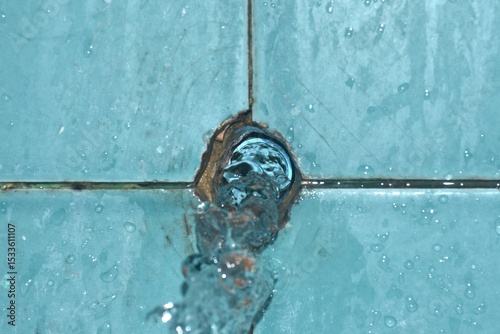 water splashing from broken plumbing blue polythene pipe line in bathroom
