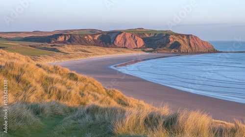 Scenic Beach Coastal Landscape with Dunes Cliffs and Sea Under Clear Sky