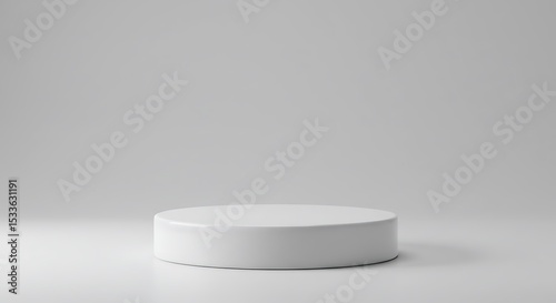 Minimalist white cylindrical display platform on gray background