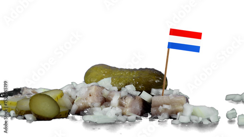 Dutch traditional salted herring in a studio setting with onions  and pickles